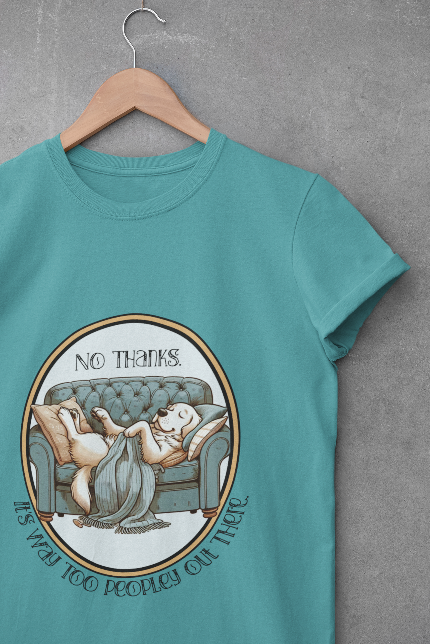 Teal unisex t-shirt with a cartoon dog relaxing on a couch and the phrase “No thanks. It’s way too peopley out there.”