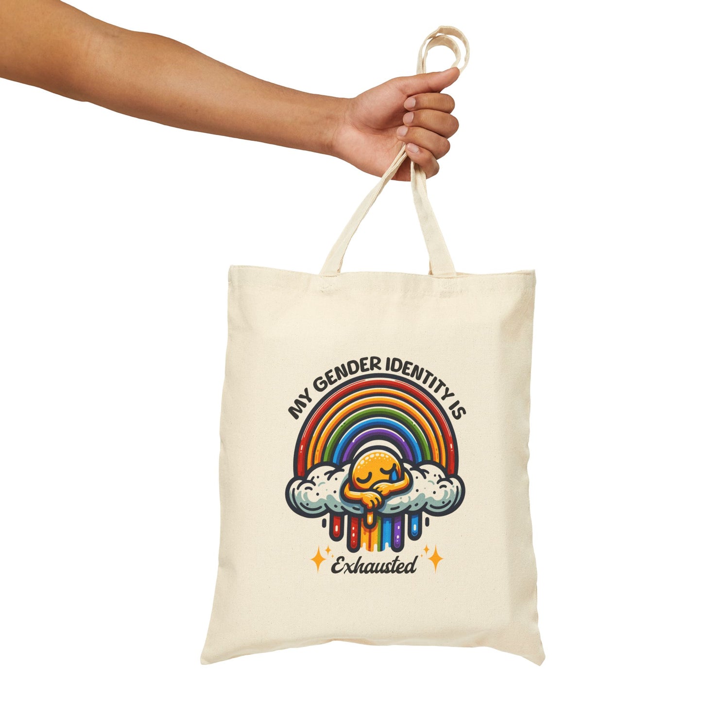 Tote bag with rainbow design and text held by a hand on a white background