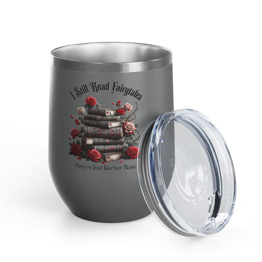 Gray tumbler with book and rose design and text 'I Still Read Fairytales, They're Just Darner Now' on a white background.