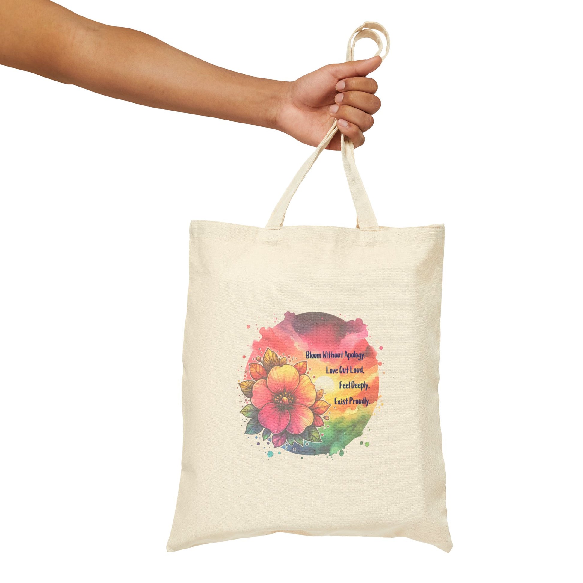 Tote bag with floral design and text held by a hand on a white background