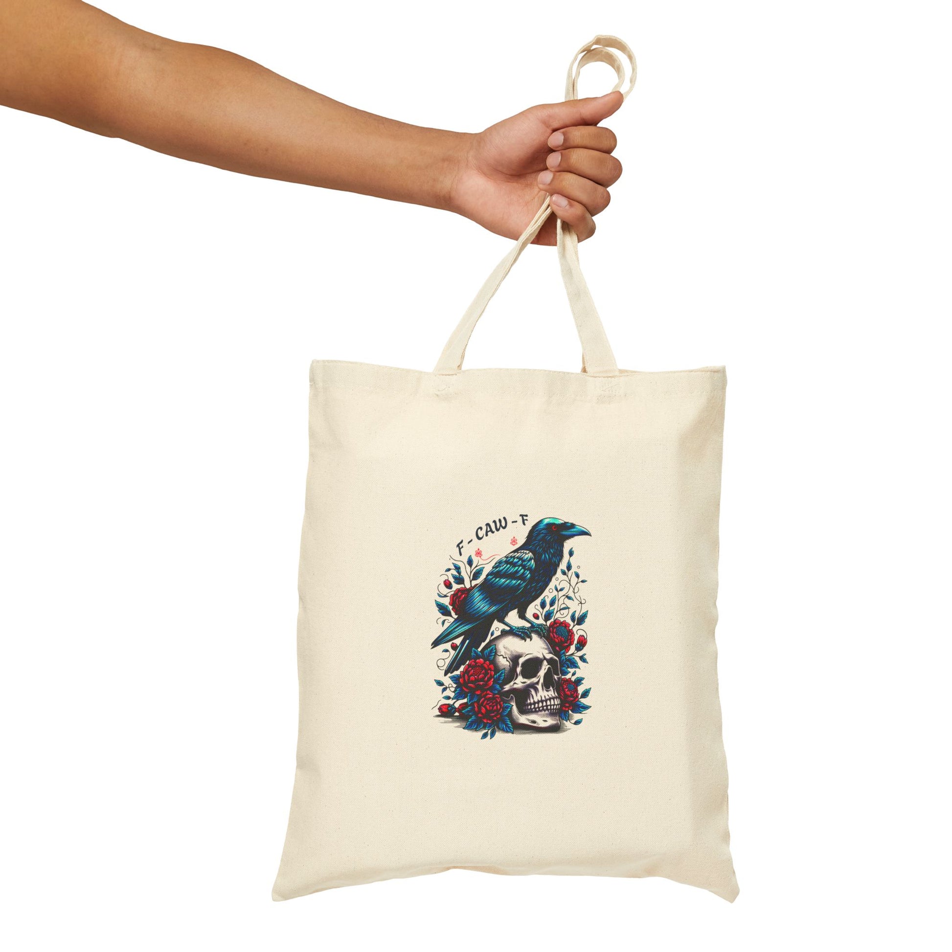 Natural canvas tote bag with an illustrated raven and skull, and the bold text “F-CAW-F” above—hinting at a not-so-subtle curse word.