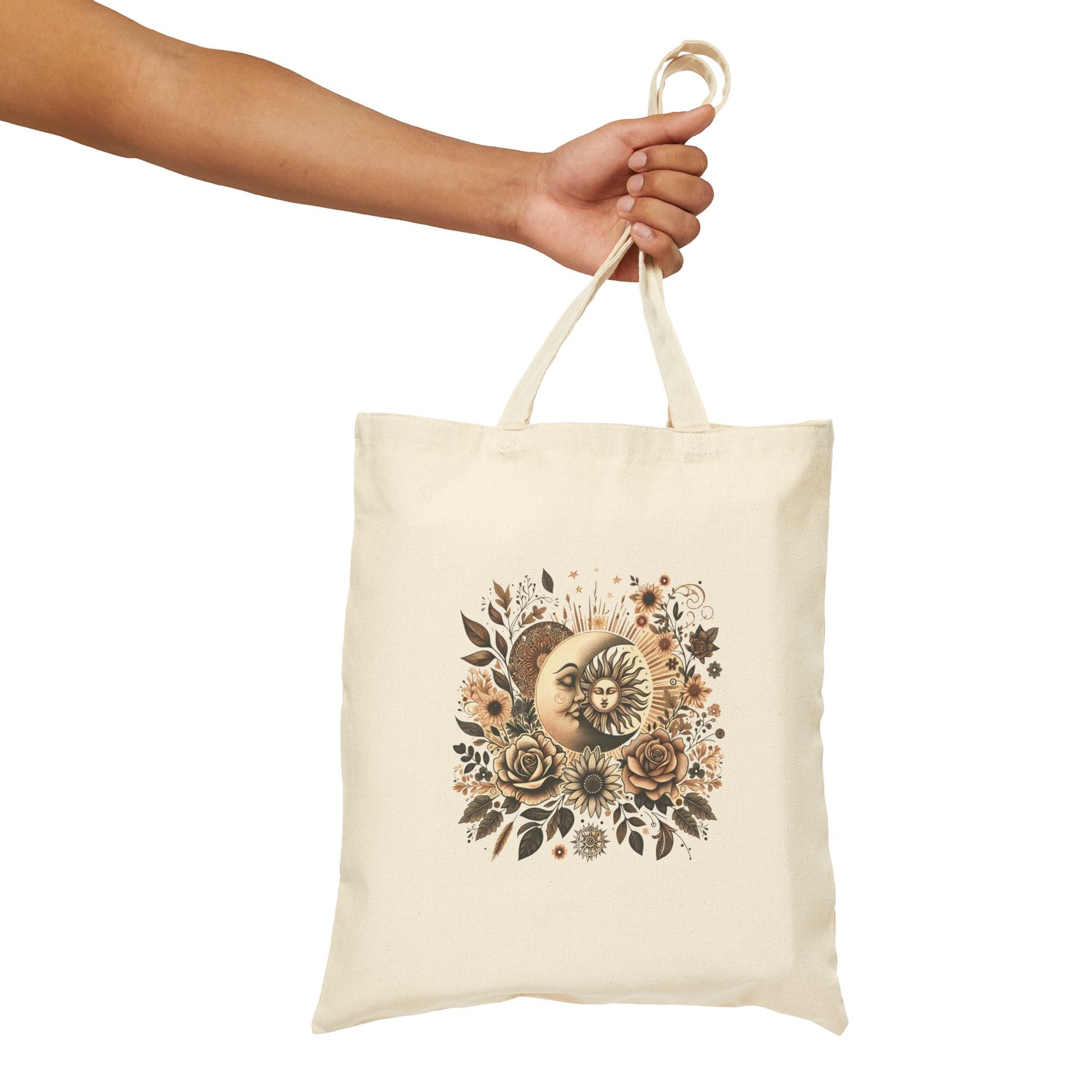 Natural cotton tote bag with a celestial design featuring a sun and moon surrounded by earthy-toned flowers and leaves.