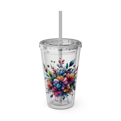 Clear tumbler with colorful floral design and straw on a white background