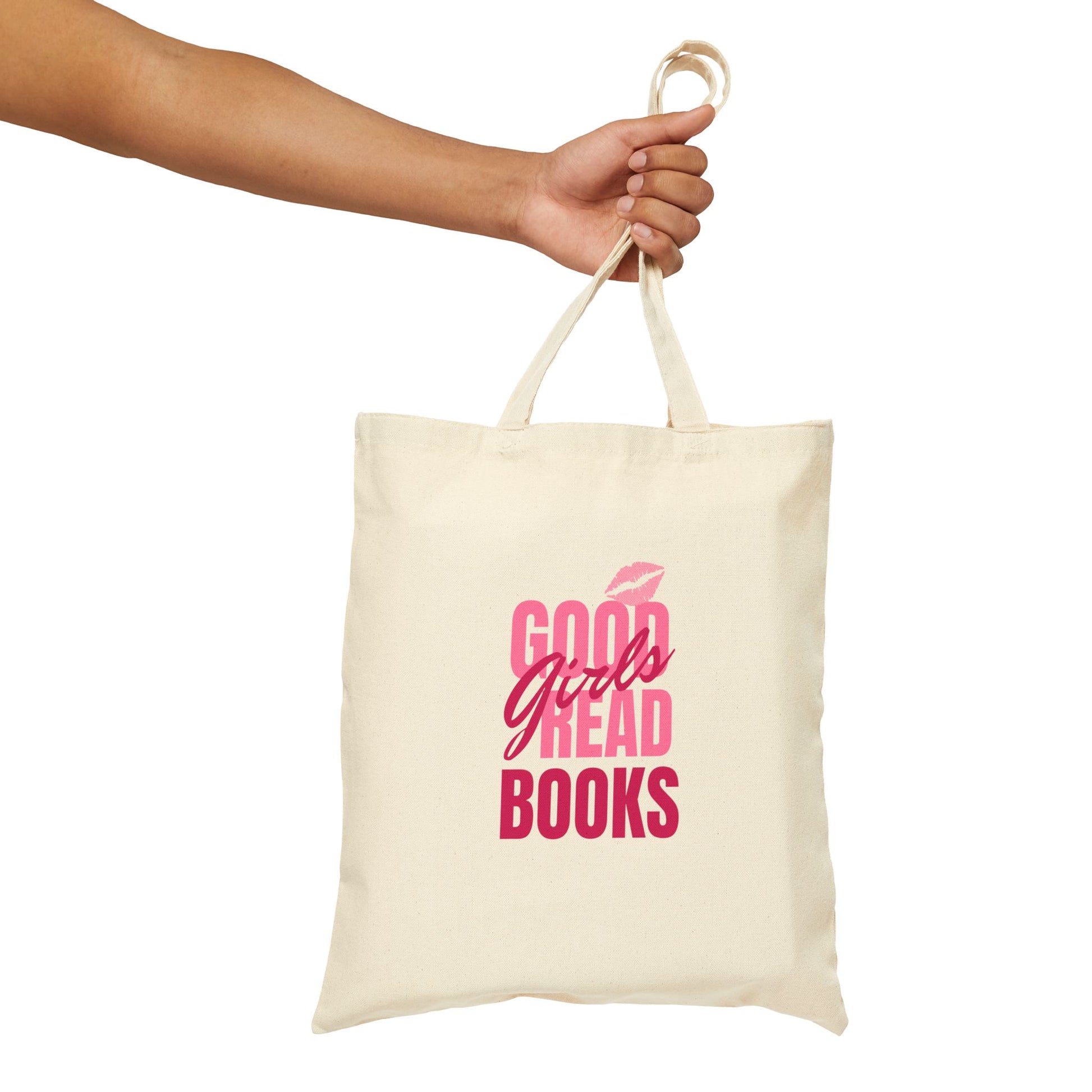 Natural cotton tote bag with pink and red text reading “Good Girls Read Books” and a kiss mark above the design.