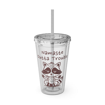 Clear tumbler with a raccoon illustration and text 'Namaste Outta Trouble' on a white background