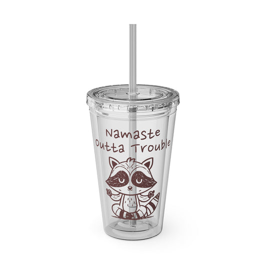 Clear tumbler with a raccoon illustration and text 'Namaste Outta Trouble' on a white background