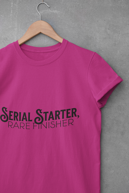 Pink t-shirt with black text that reads “Serial Starter, Rare Finisher” – funny and relatable graphic tee for casual everyday wear.