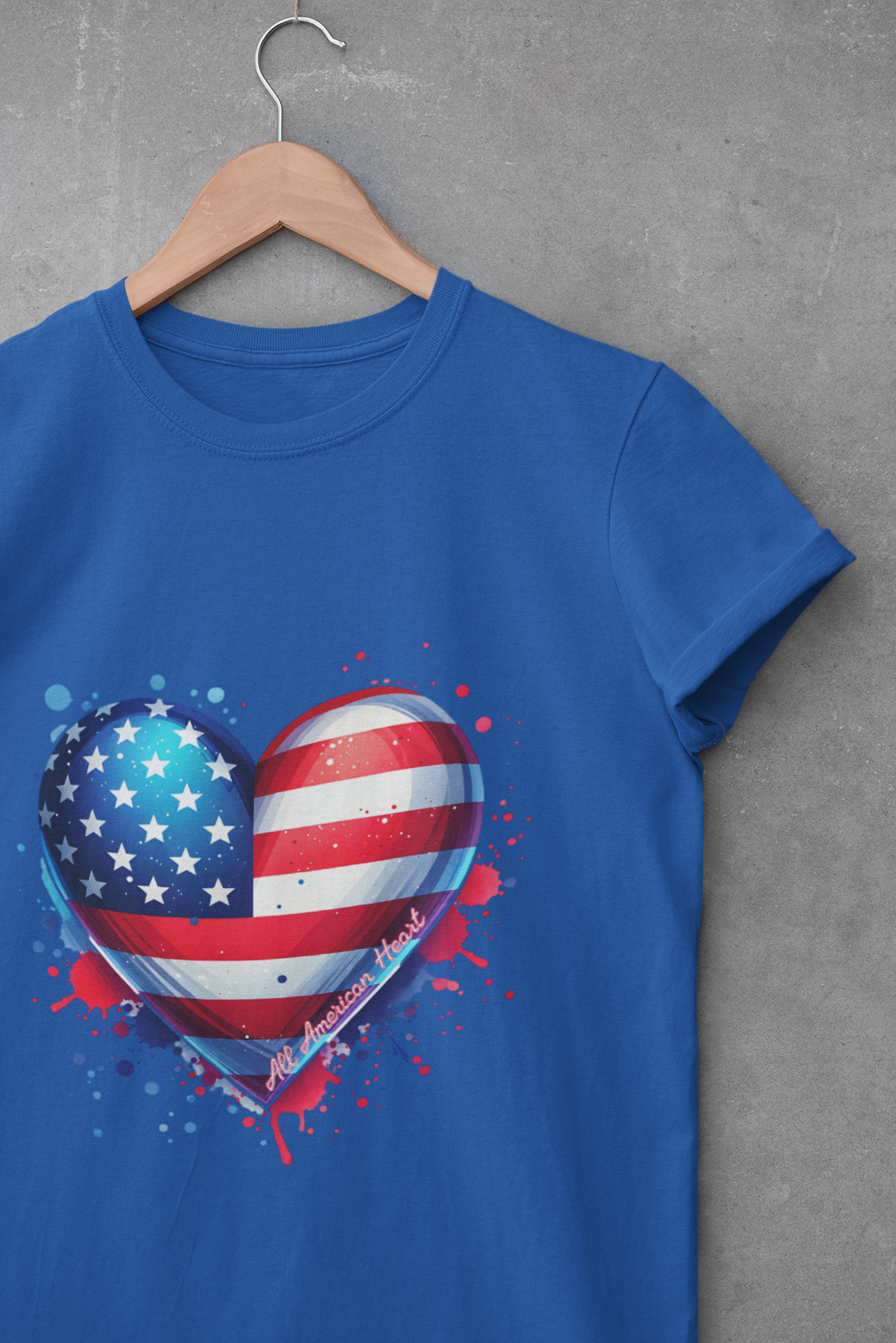 Blue unisex t-shirt with a heart-shaped American flag design and paint splatter accents, symbolizing patriotic pride.