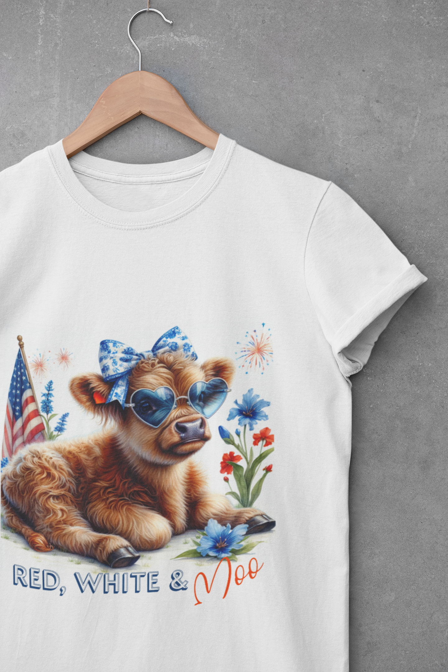 White t-shirt with a cute calf wearing patriotic sunglasses and bow, surrounded by fireworks, flowers, and the phrase “Red, White & Moo”