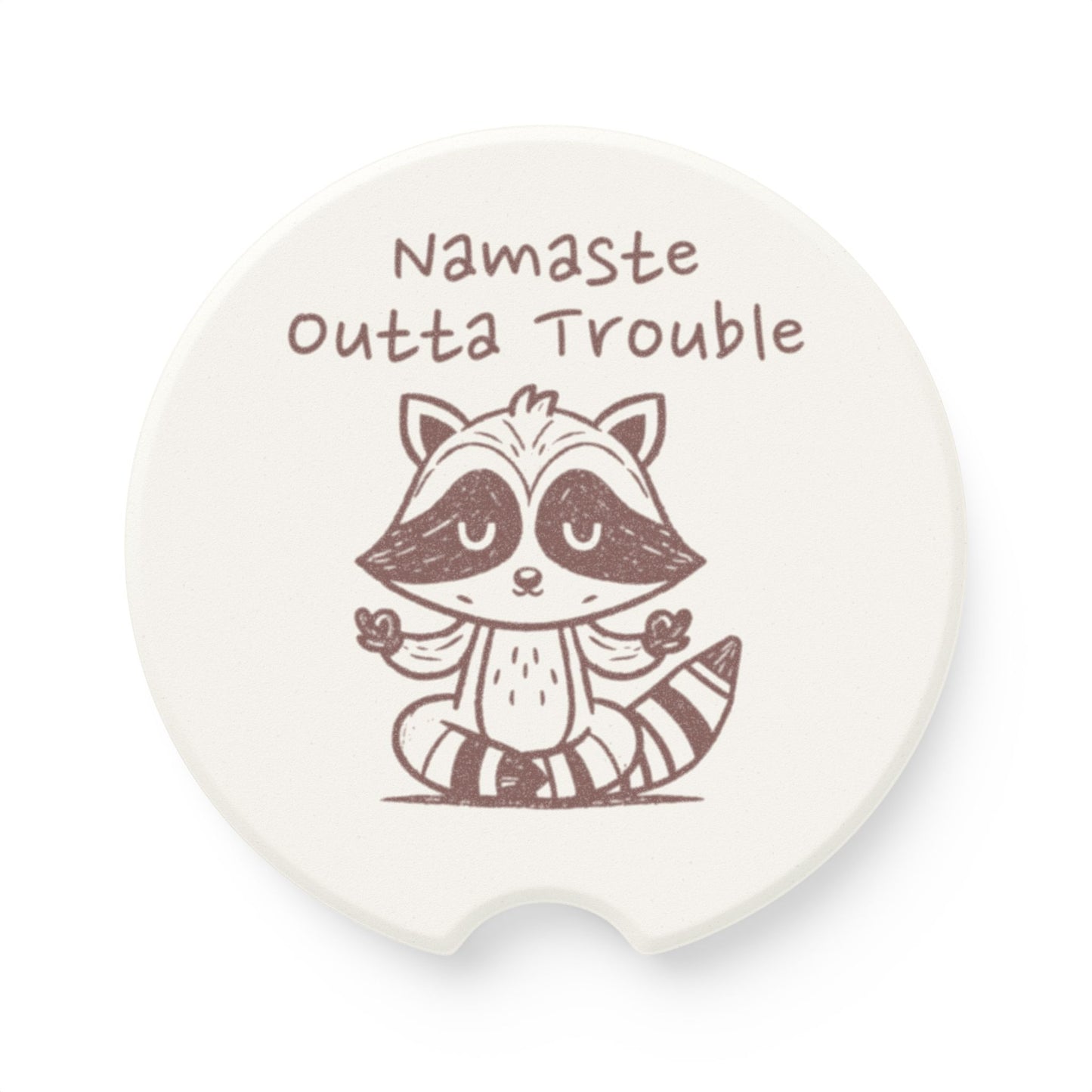 Soapstone coaster with a raccoon illustration and 'Namaste Outta Trouble' text on a white background