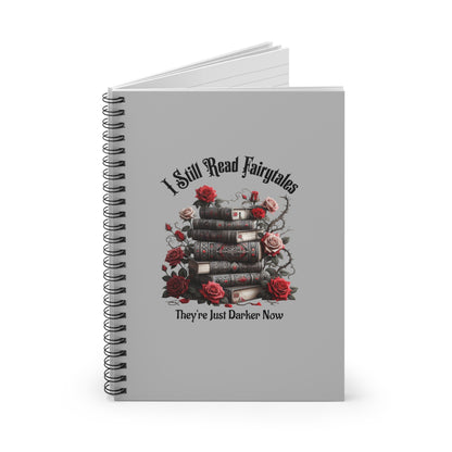 Notebook with spiral binding and decorative design on a white background