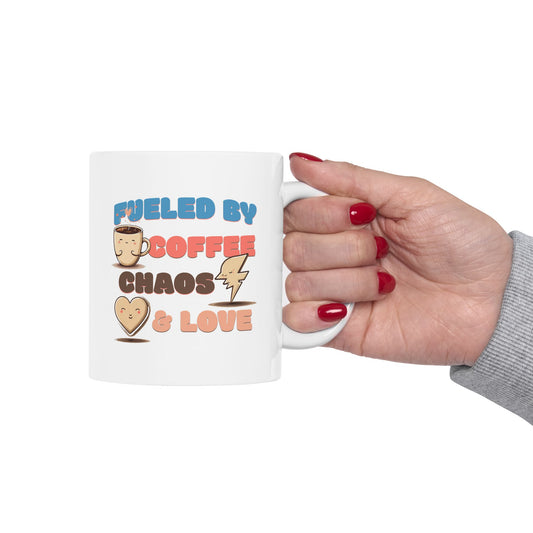 Ceramic mug with colorful text reading “Fueled by Coffee, Chaos & Love” and cute coffee, lightning, and heart icons – fun mug for coffee lovers